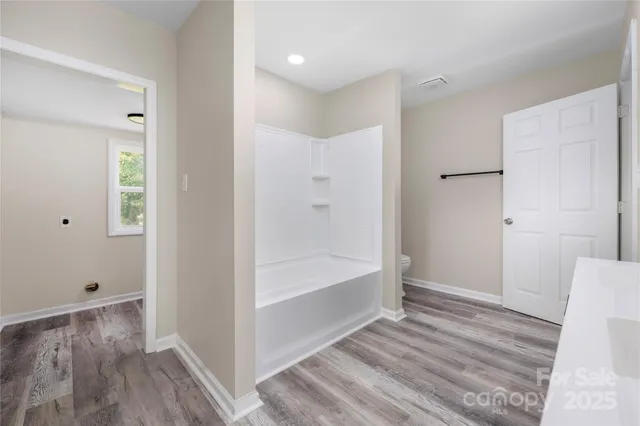 a bathroom with a bathtub and shower