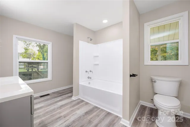 a bathroom with a toilet sink and tub