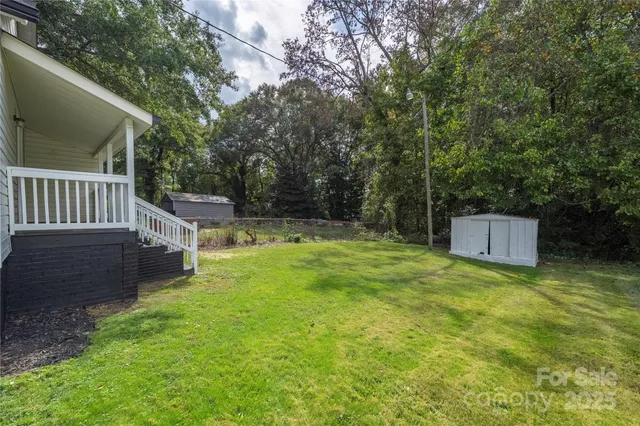 a view of a deck with a fence and trees