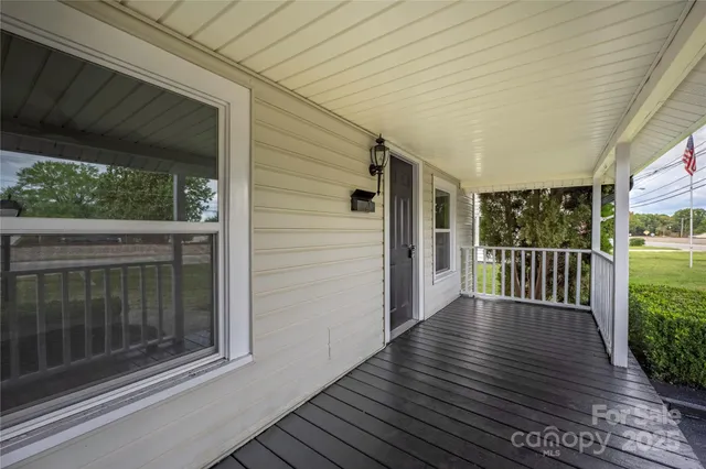 a view of a porch with wooden floor and outdoor space