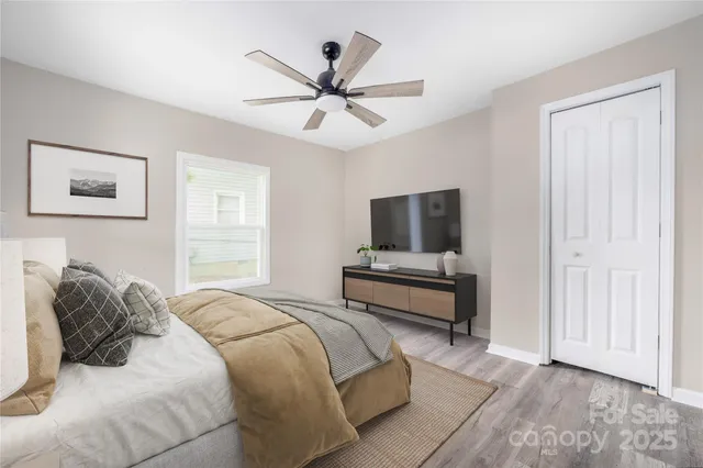 a bedroom with a bed and a flat screen tv