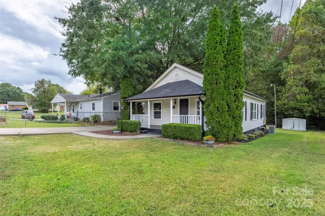 a front view of a house with swimming pool having outdoor seating