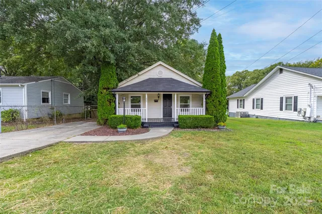 a front view of a house with a yard and porch