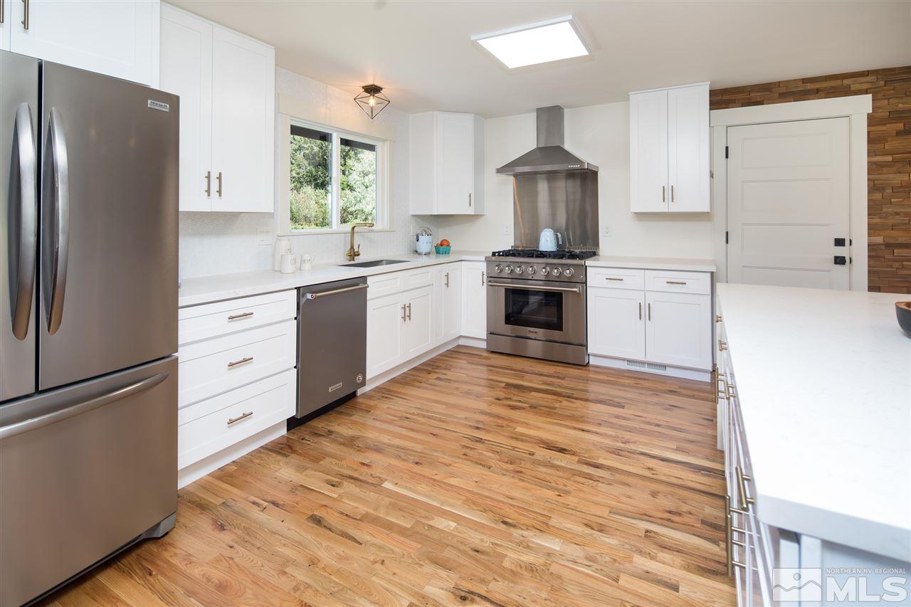 20 Skyline Circle Reno, NV 89509 - Photo 8 of 24 a kitchen with white cabinets and stainless steel appliances