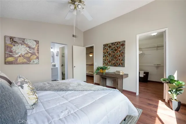 a bedroom with a large bed and a chandelier