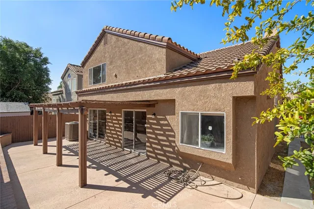 a view of a house with a yard and potted plants