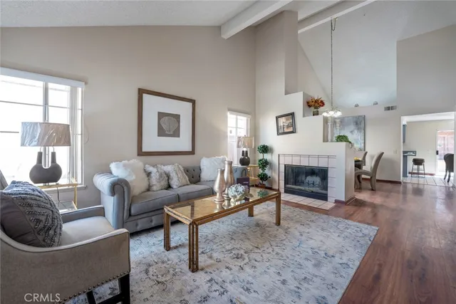 a living room with furniture a fireplace and a table