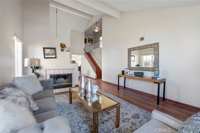 a living room with furniture a fireplace and a potted plant
