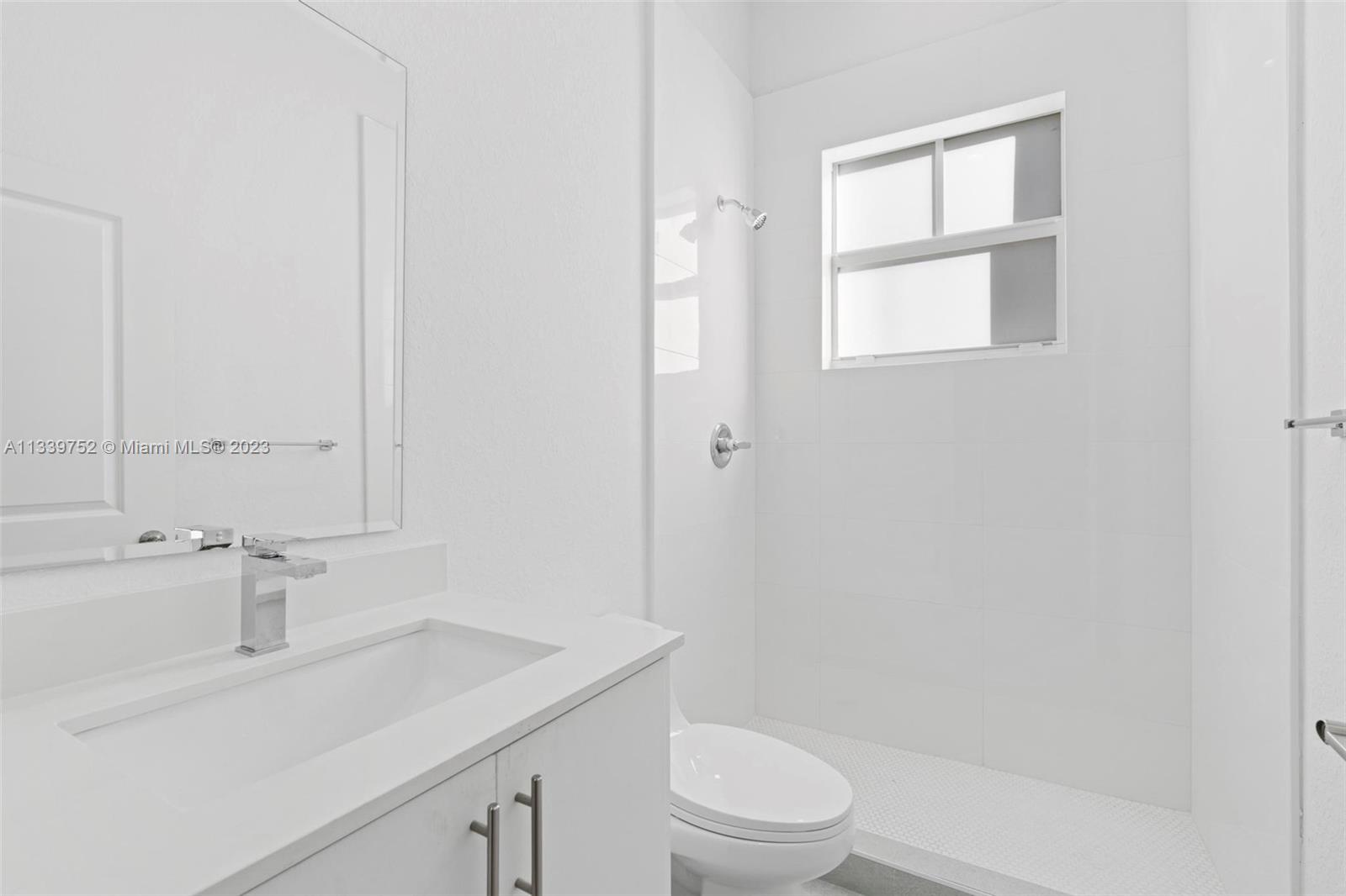 24721 Southwest 112th Court Homestead, FL 33032 - Photo 18 of 40 a bathroom with a sink toilet and vanity