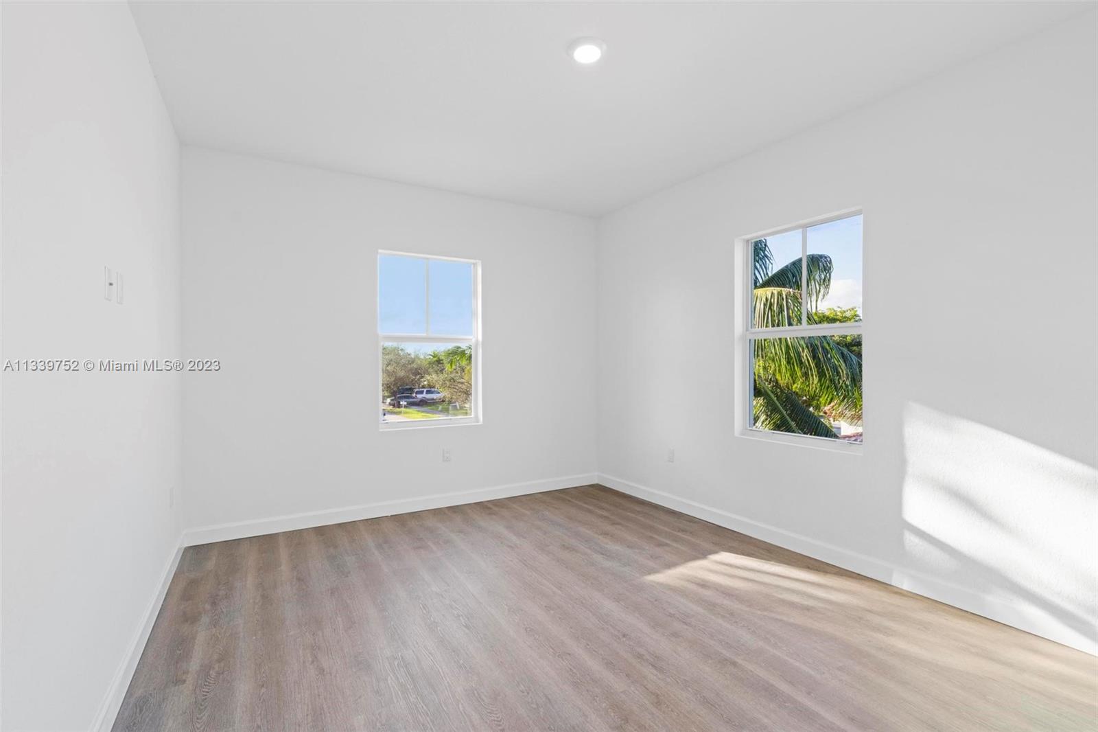 24721 Southwest 112th Court Homestead, FL 33032 - Photo 27 of 40 an empty room with wooden floor and window