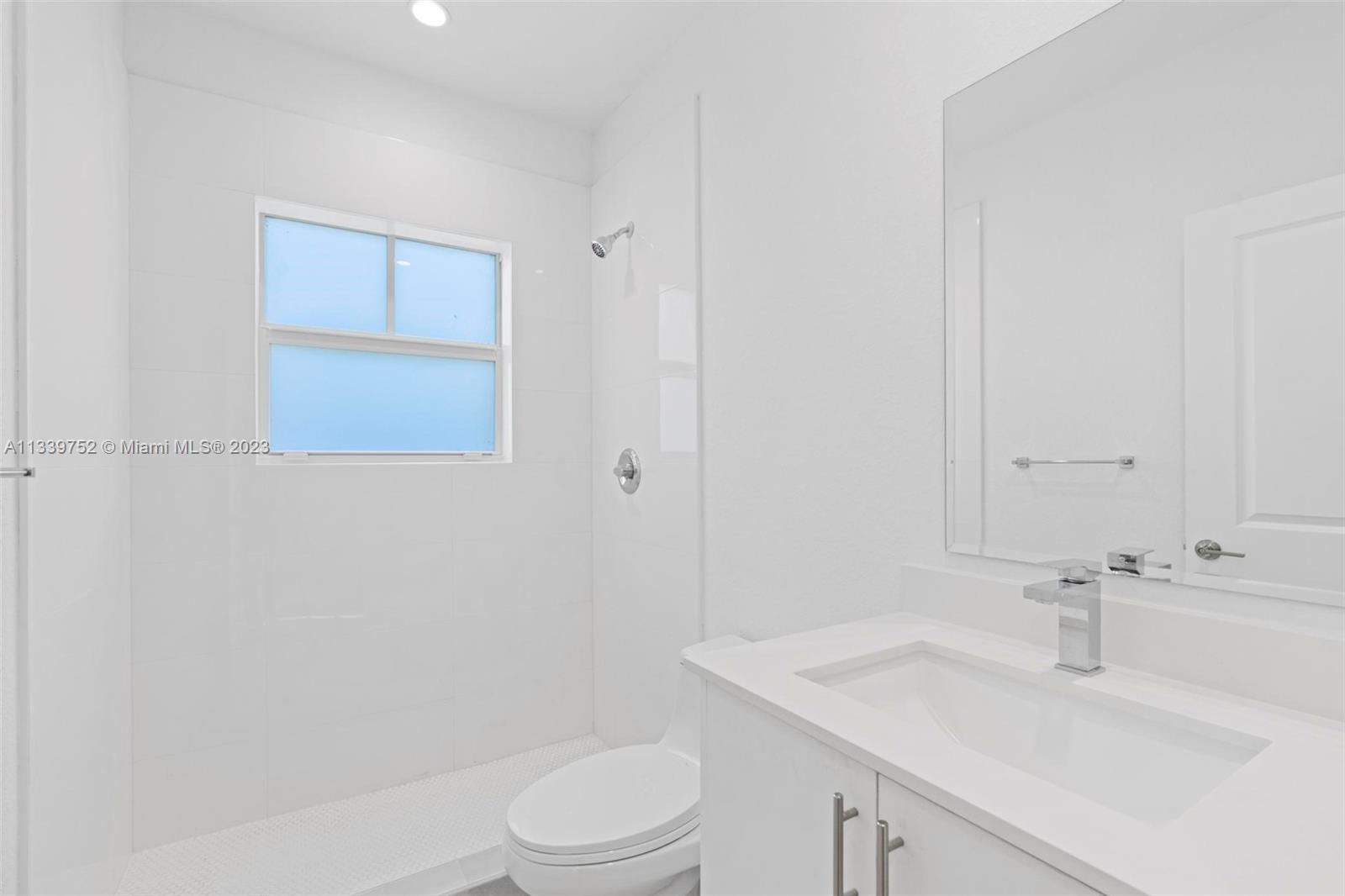 24721 Southwest 112th Court Homestead, FL 33032 - Photo 28 of 40 a bathroom with a sink a toilet and vanity