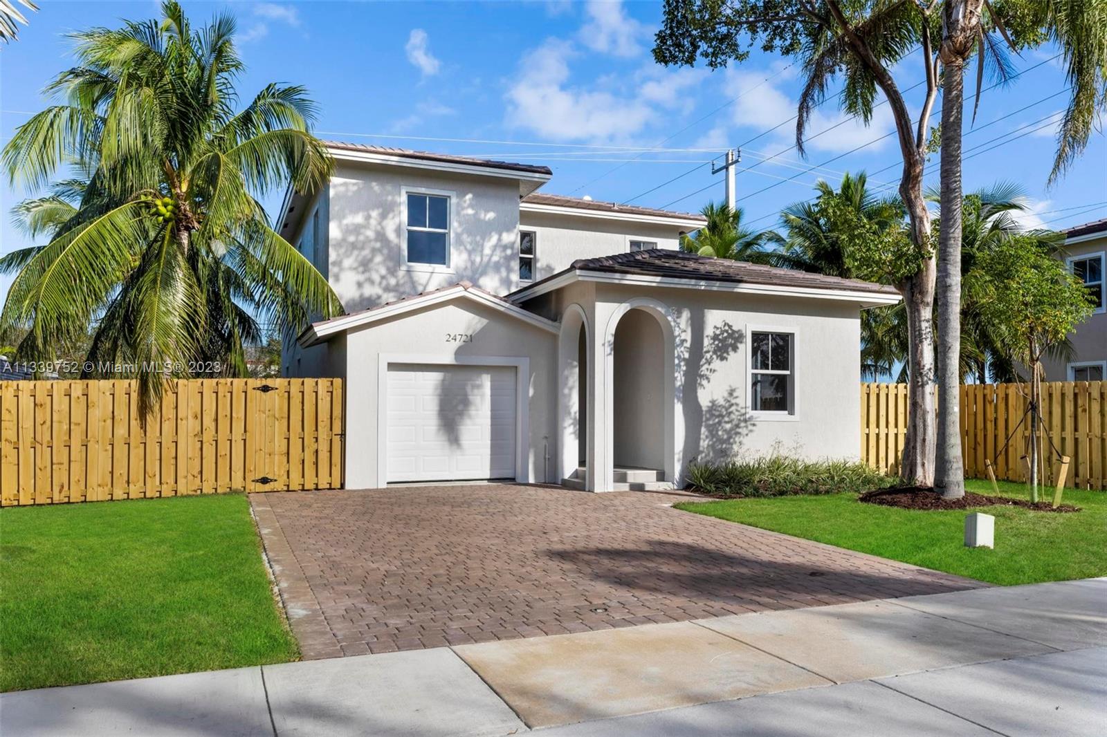 24721 Southwest 112th Court Homestead, FL 33032 - Photo 3 of 40 a front view of a house with a garden and trees
