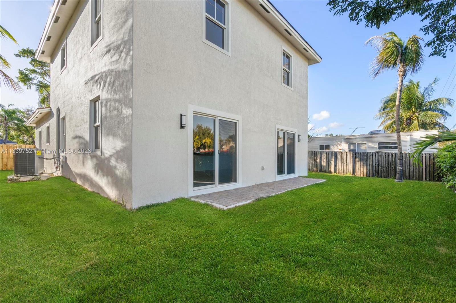24721 Southwest 112th Court Homestead, FL 33032 - Photo 35 of 40 a view of a house with a yard and a garage
