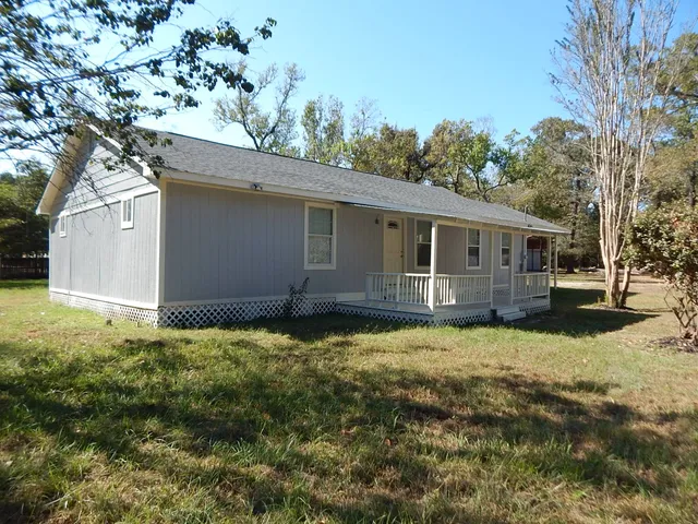 a backyard of a house with yard and tree