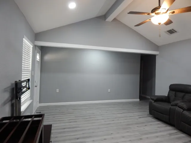 wooden floor in an empty room with a window