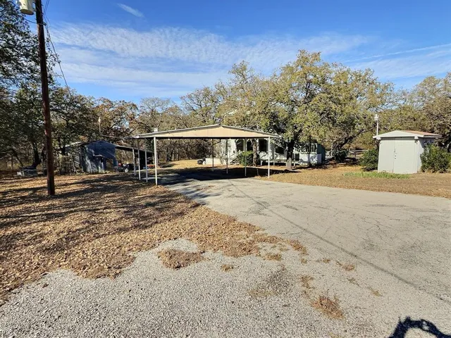 a view of a large white house in the middle of a yard