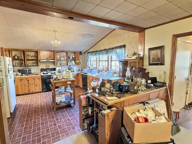 a kitchen with stainless steel appliances granite countertop a stove a sink dishwasher and cabinets with wooden floor