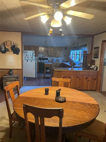 a view of a dining room with furniture a chandelier and wooden floor