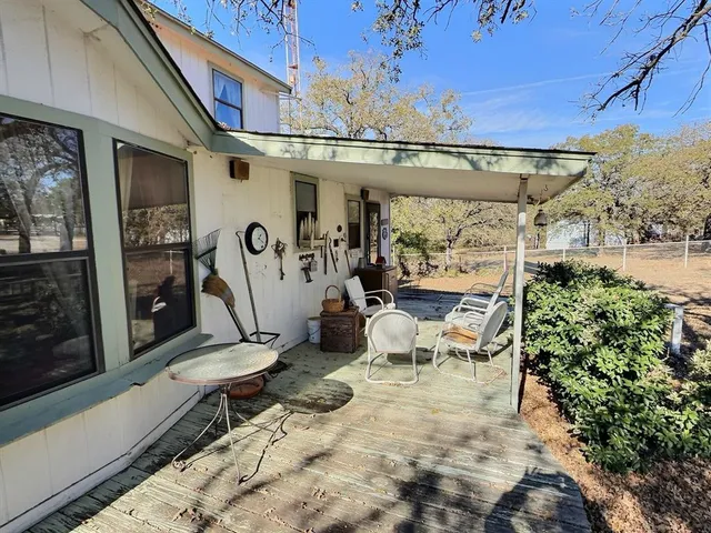 a view of a chairs and table in a patio