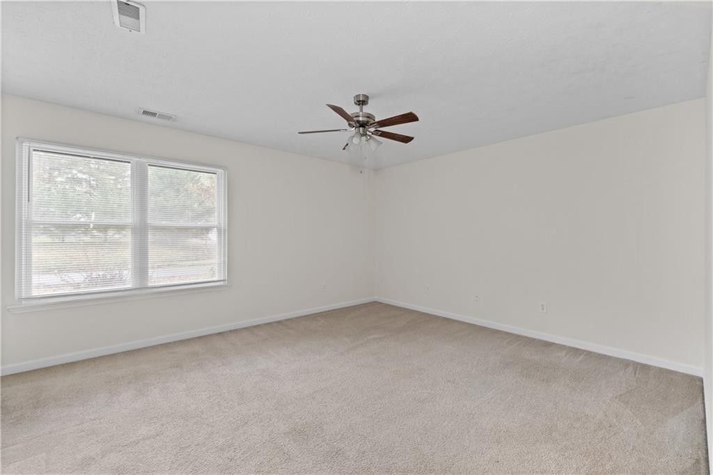5900 Jacobs Road Acworth, GA 30102 - Photo 12 of 18 an empty room with a window and a ceiling fan