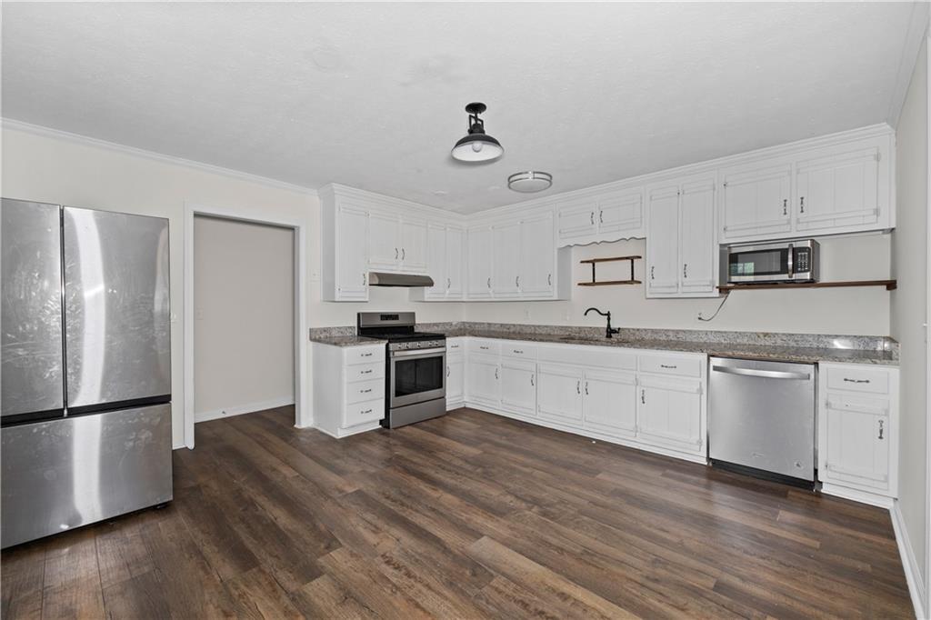 5900 Jacobs Road Acworth, GA 30102 - Photo 7 of 18 a large kitchen with cabinets wooden floor and stainless steel appliances