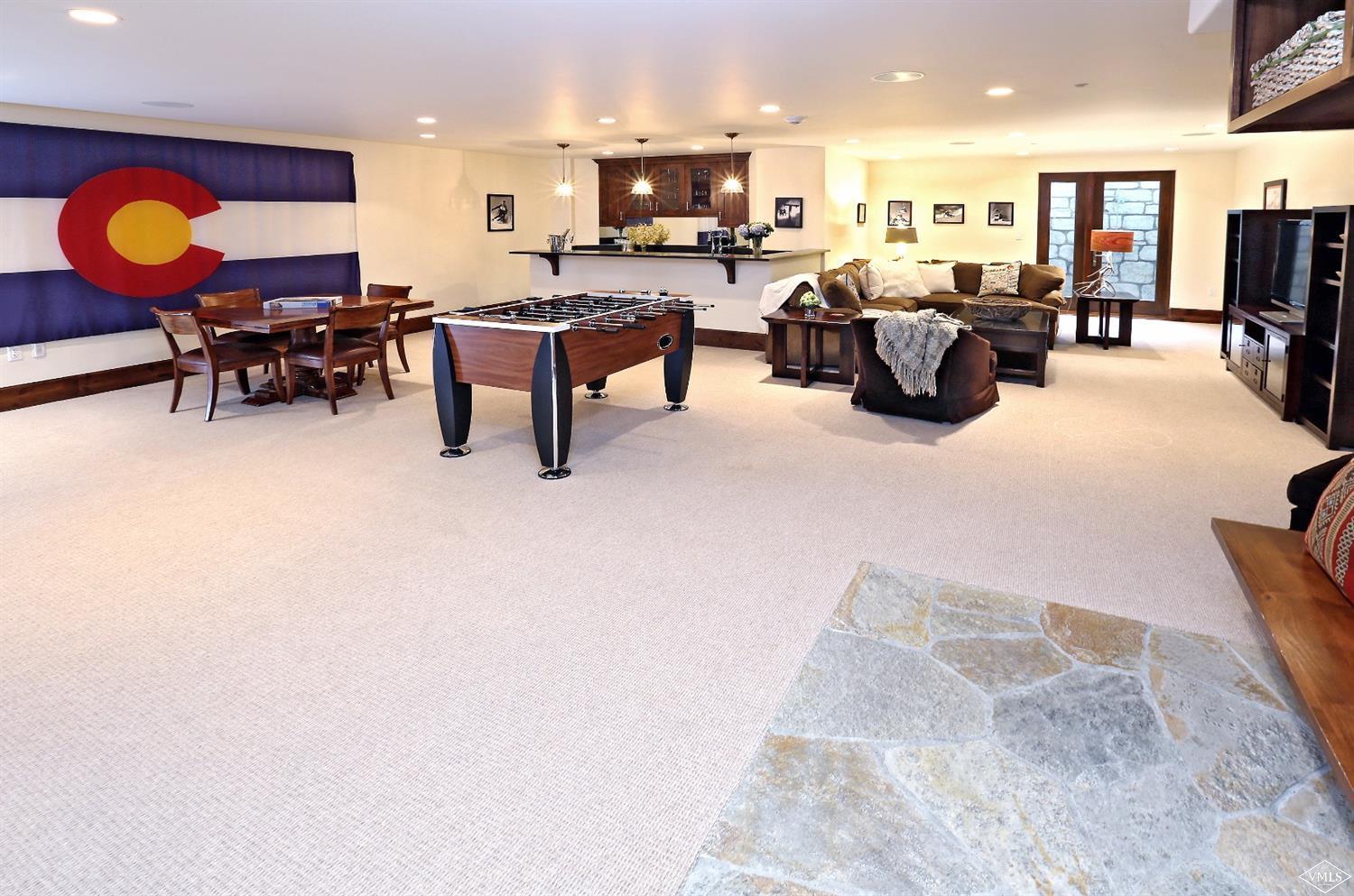 151 Vail Road, Unit 3 Vail, CO 81657 - Photo 13 of 25 a living room with furniture kitchen view and a flat screen tv