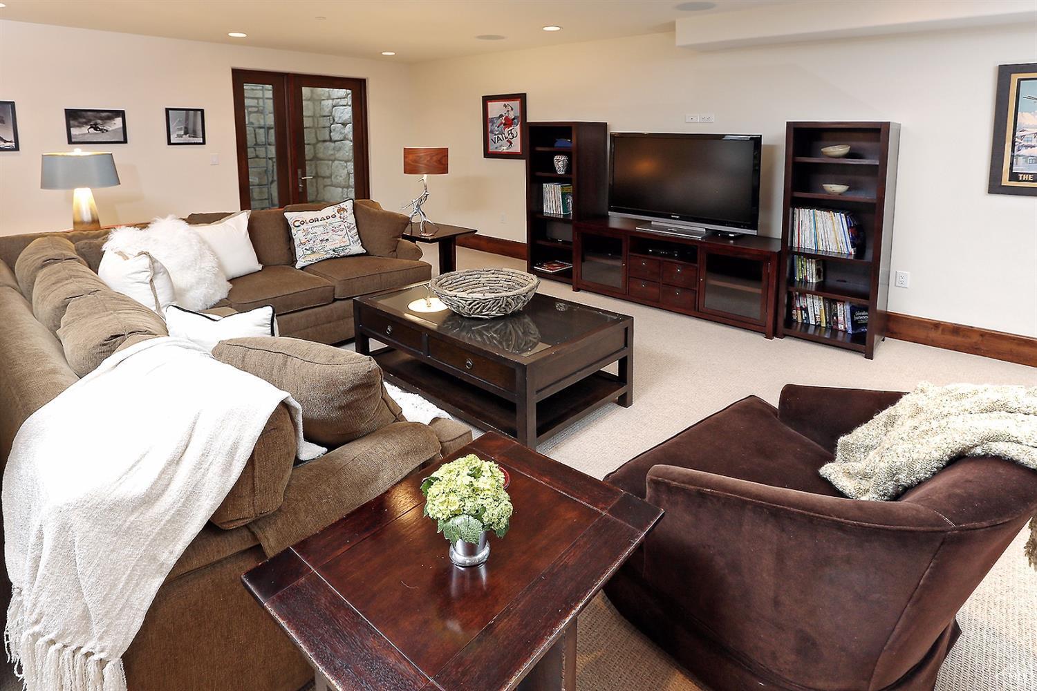 151 Vail Road, Unit 3 Vail, CO 81657 - Photo 15 of 25 a living room with furniture and a flat screen tv