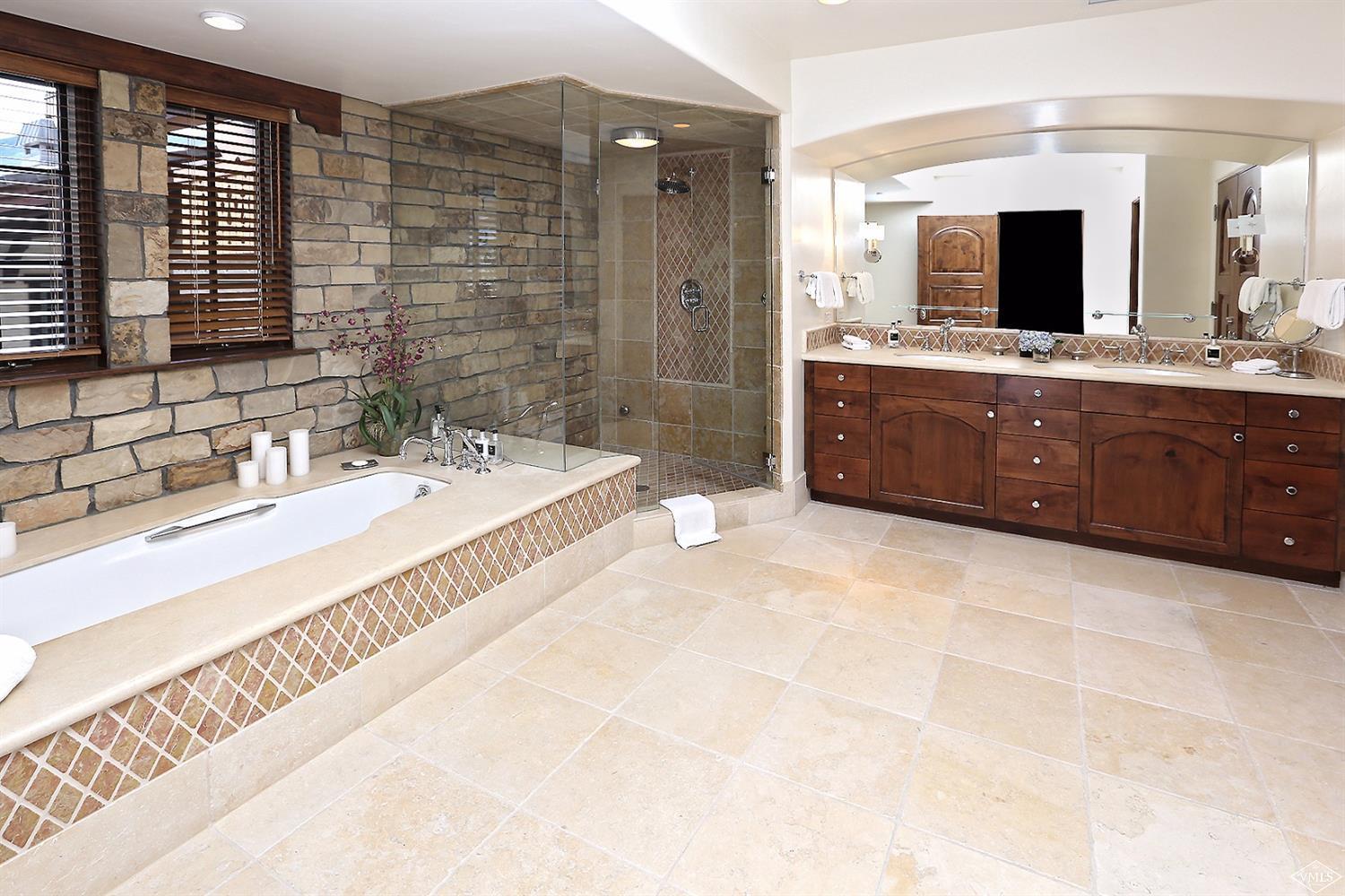 151 Vail Road, Unit 3 Vail, CO 81657 - Photo 17 of 25 a spacious bathroom with a tub double sink and mirror