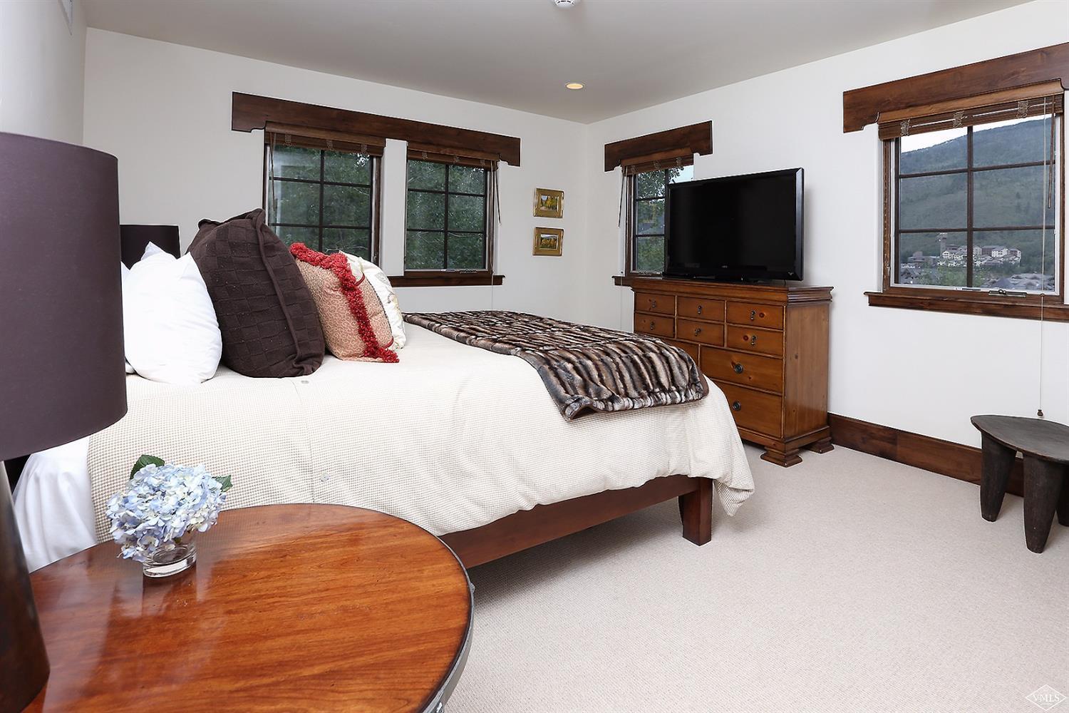 151 Vail Road, Unit 3 Vail, CO 81657 - Photo 19 of 25 a bedroom with a bed and flat screen tv