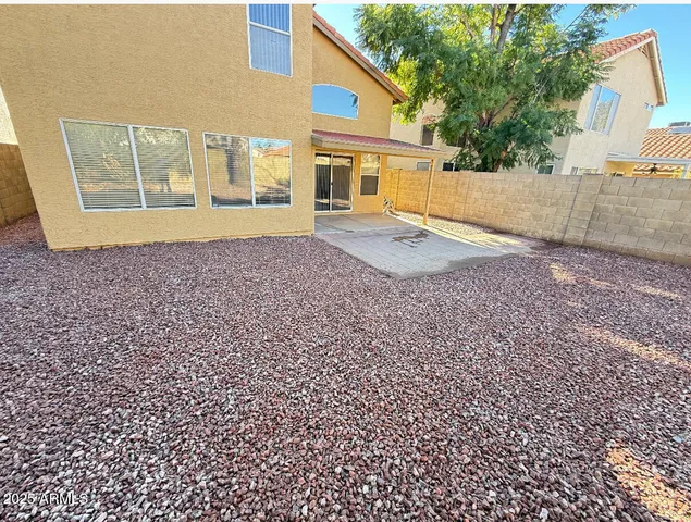 a view of a house with a backyard