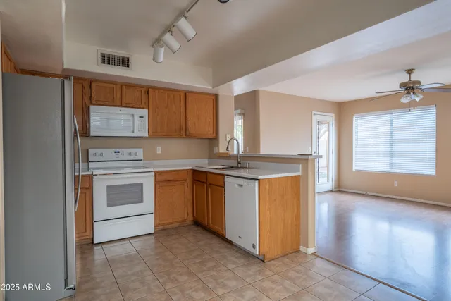 a kitchen with granite countertop cabinets stainless steel appliances and a window
