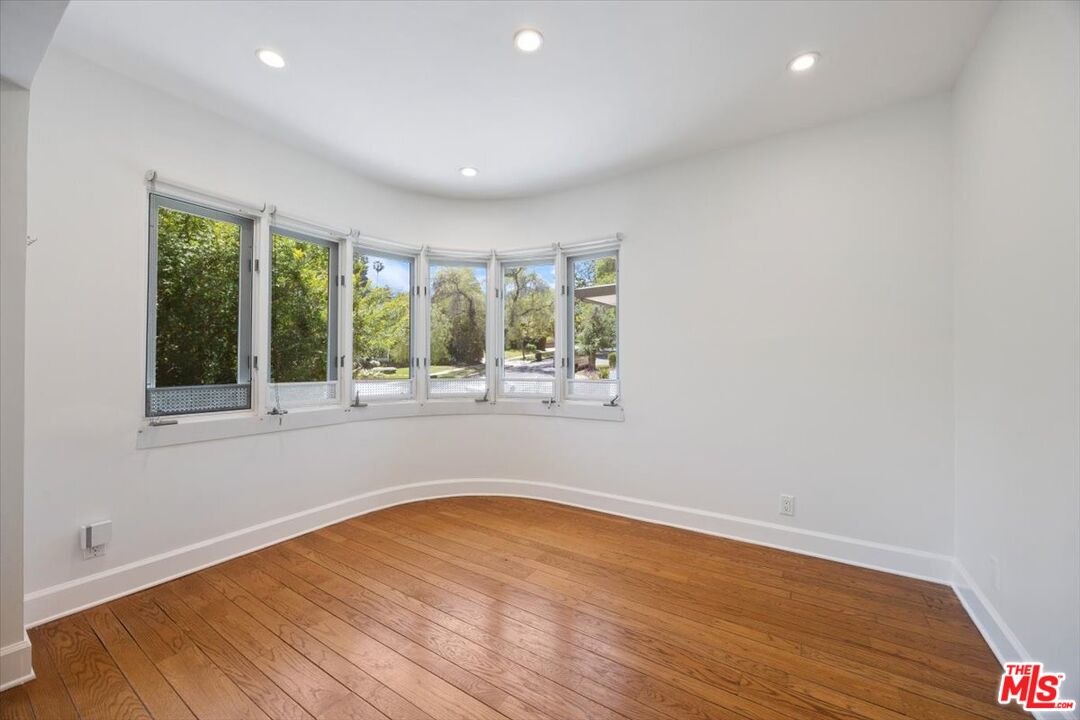 14041 Roblar Road Sherman Oaks, CA 91423 - Photo 11 of 47 a view of empty room with wooden floor and fan