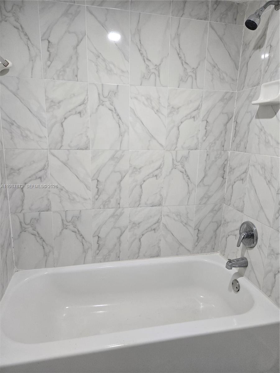 3400 Foxcroft Road, Unit 209 Miramar, FL 33025 - Photo 13 of 19 a bathroom with a bathtub