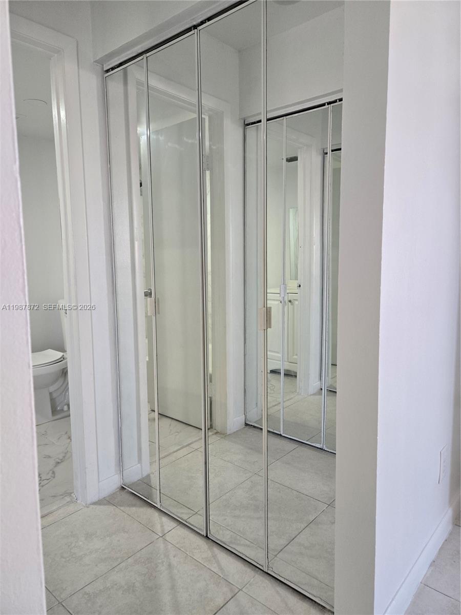 3400 Foxcroft Road, Unit 209 Miramar, FL 33025 - Photo 16 of 19 a bathroom with a glass shower door