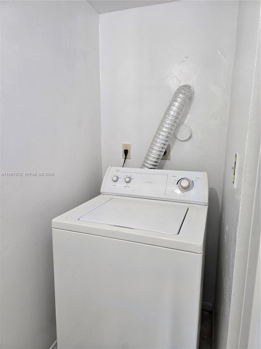 3400 Foxcroft Road, Unit 209 Miramar, FL 33025 - Photo 17 of 19 a utility room with dryer and washer