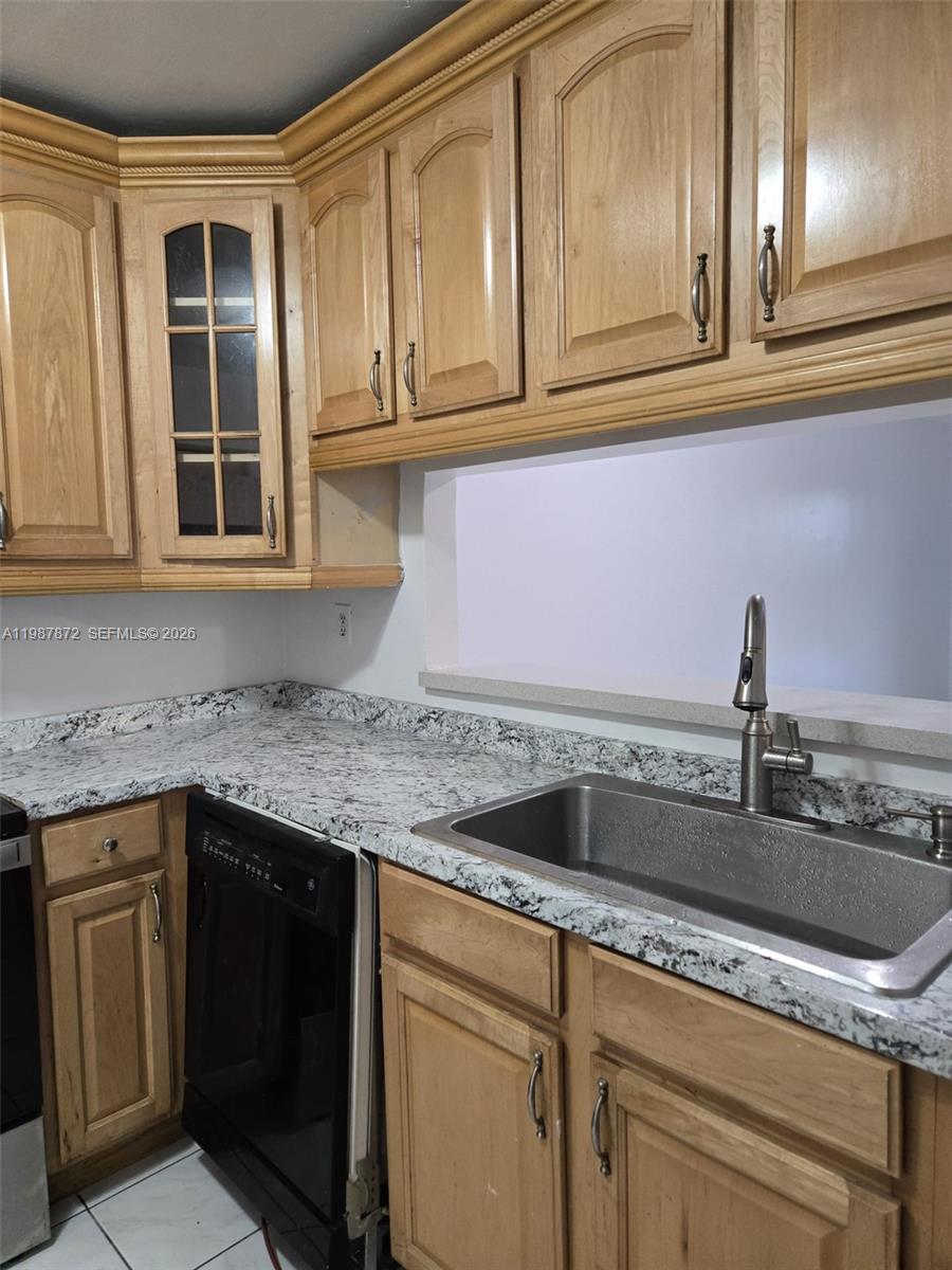 3400 Foxcroft Road, Unit 209 Miramar, FL 33025 - Photo 6 of 19 a kitchen with granite countertop stainless steel appliances sink and cabinets