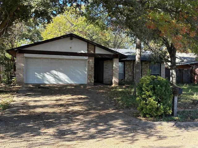 a house that has a tree in front of it