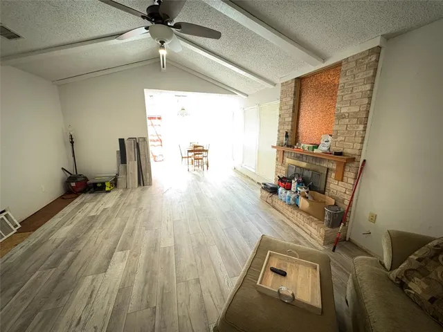 a view of a room with wooden floor and furniture