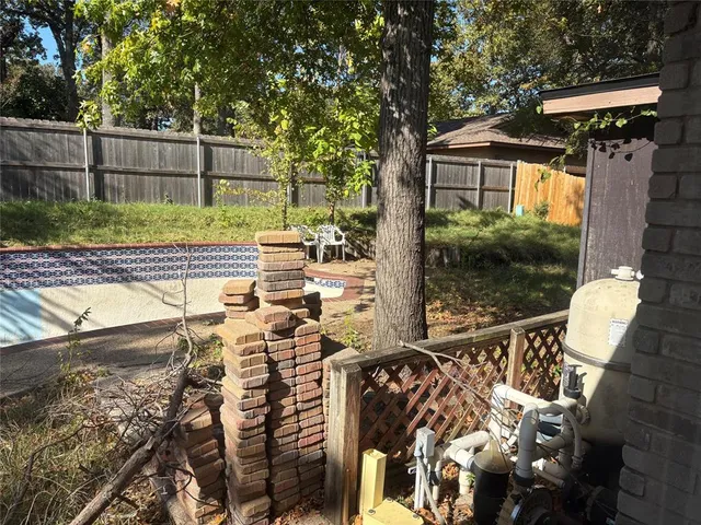 a view of backyard with plants and outdoor seating