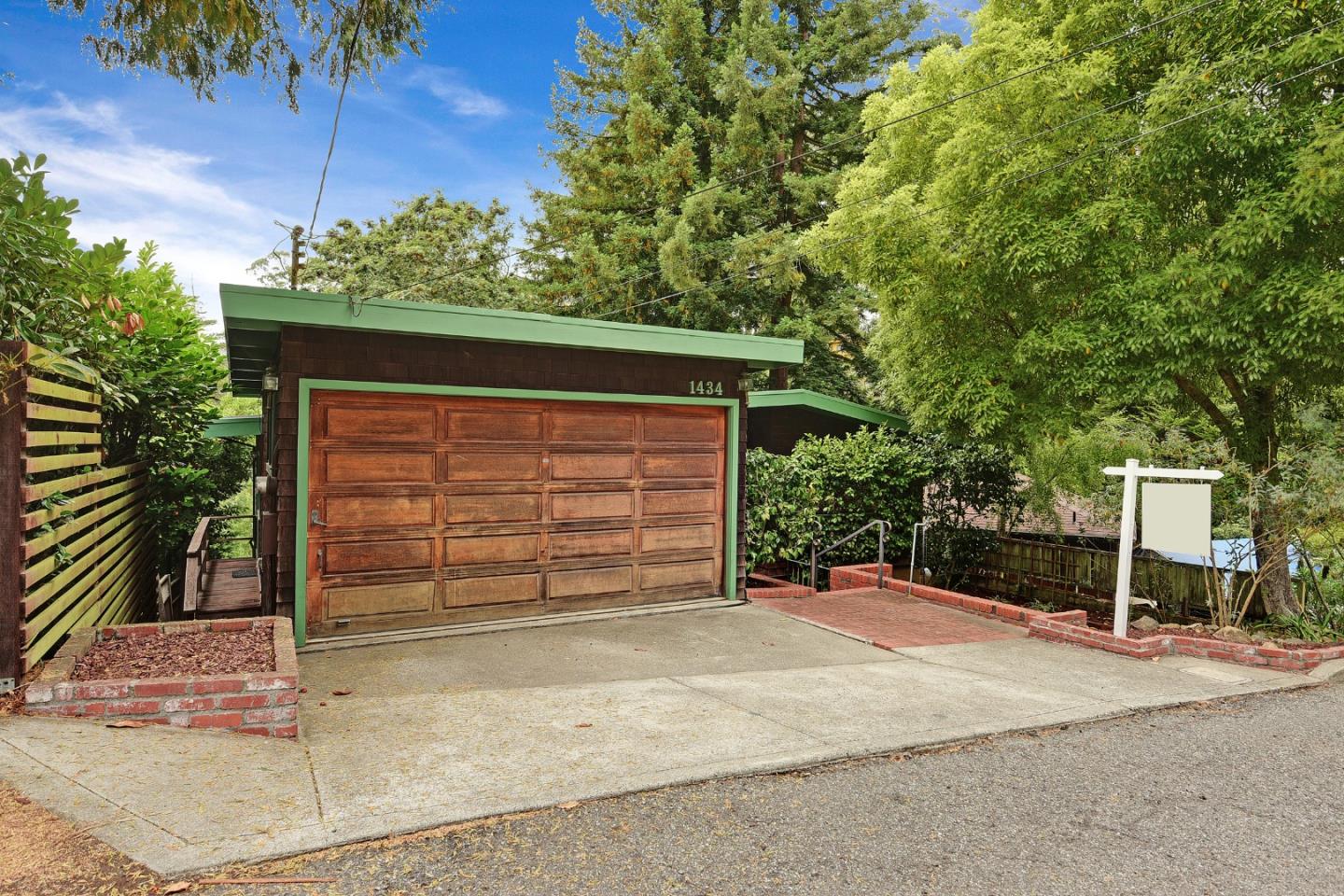 1434 Queens Road Berkeley, CA 94708 - Photo 3 of 32 a front view of a house with a yard and garage