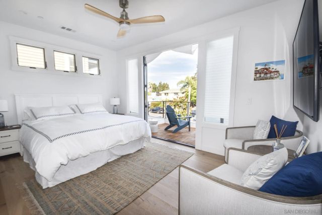 a bedroom with a large bed and a flat screen tv