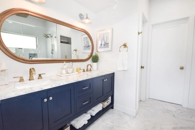 a bathroom with a double vanity sink and mirror