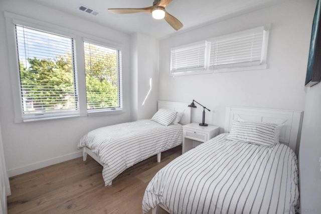 a bedroom with two beds and a window