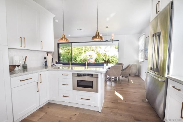 a kitchen with a stove a sink and a refrigerator