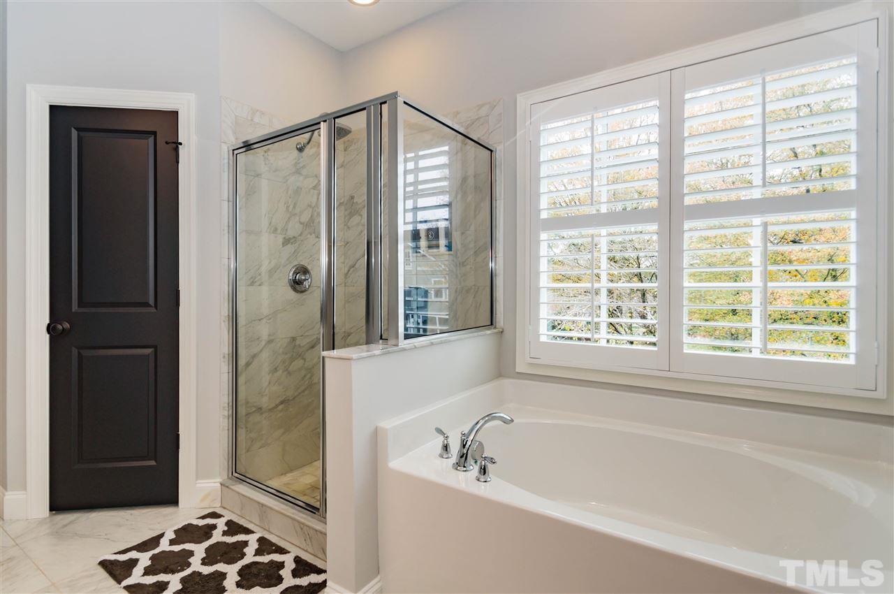 511 Mial Street Raleigh, NC 27608 - Photo 16 of 25 a bathroom with a bathtub and a shower