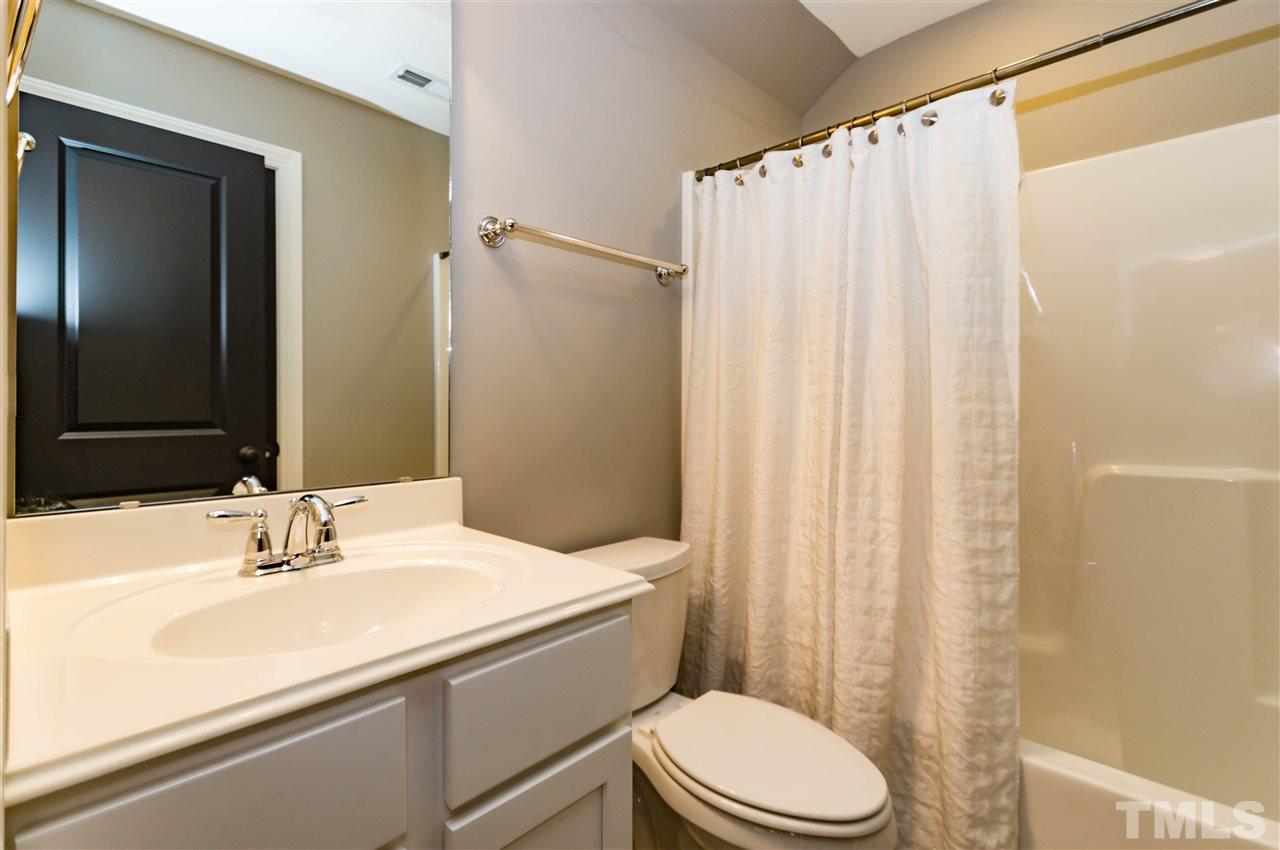 511 Mial Street Raleigh, NC 27608 - Photo 22 of 25 a bathroom with a sink a toilet and shower
