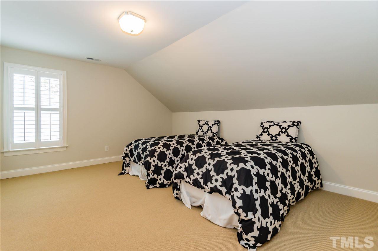 511 Mial Street Raleigh, NC 27608 - Photo 23 of 25 a bed sitting in a bedroom next to a window