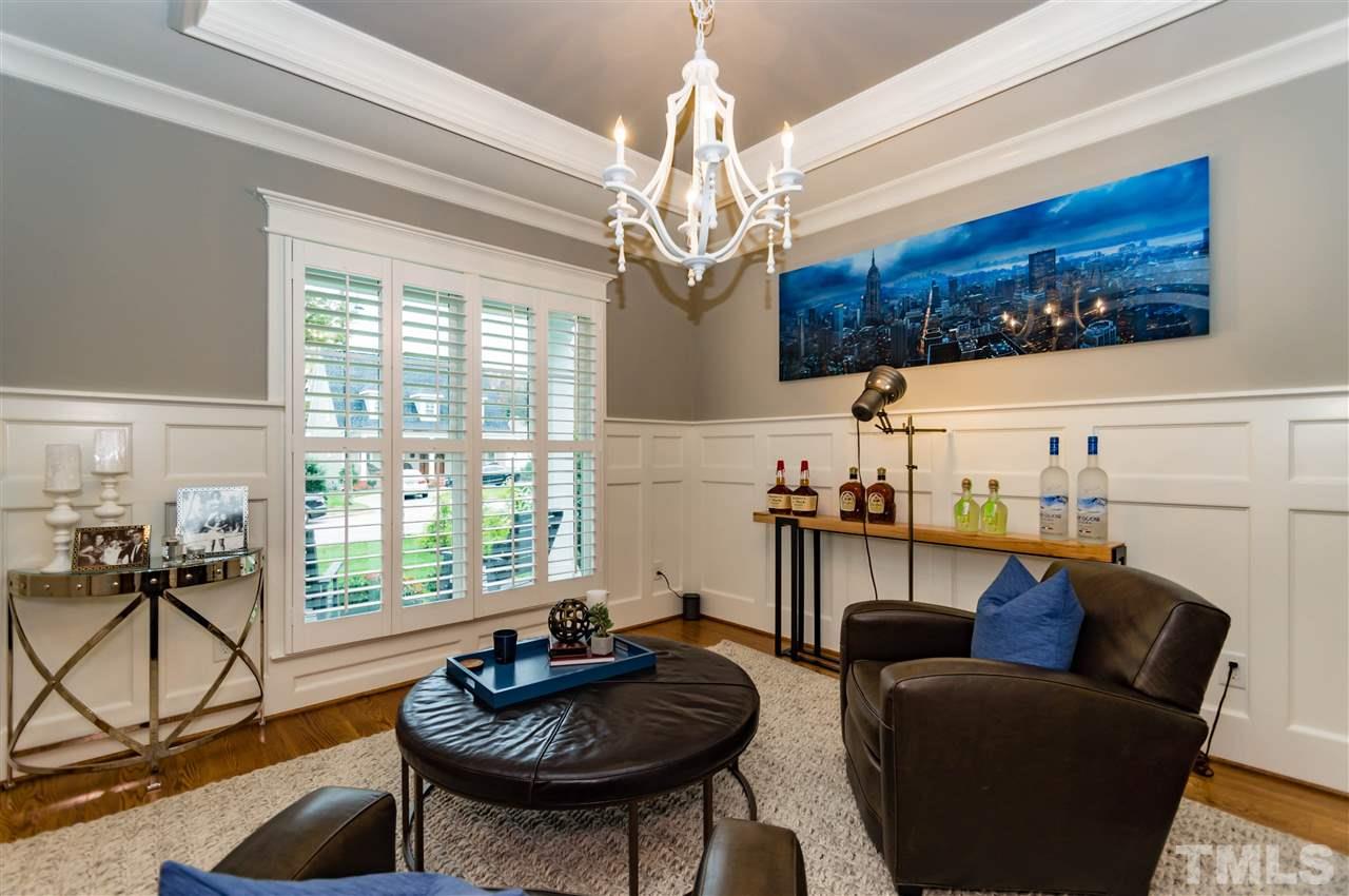 511 Mial Street Raleigh, NC 27608 - Photo 4 of 25 a living room with furniture a chandelier and a flat screen tv