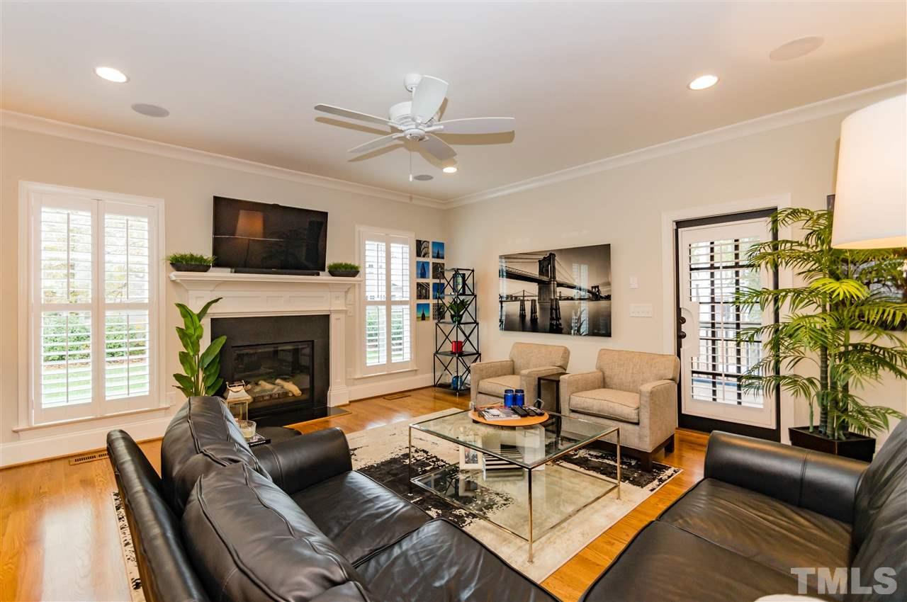 511 Mial Street Raleigh, NC 27608 - Photo 5 of 25 a living room with furniture a fireplace and a flat screen tv