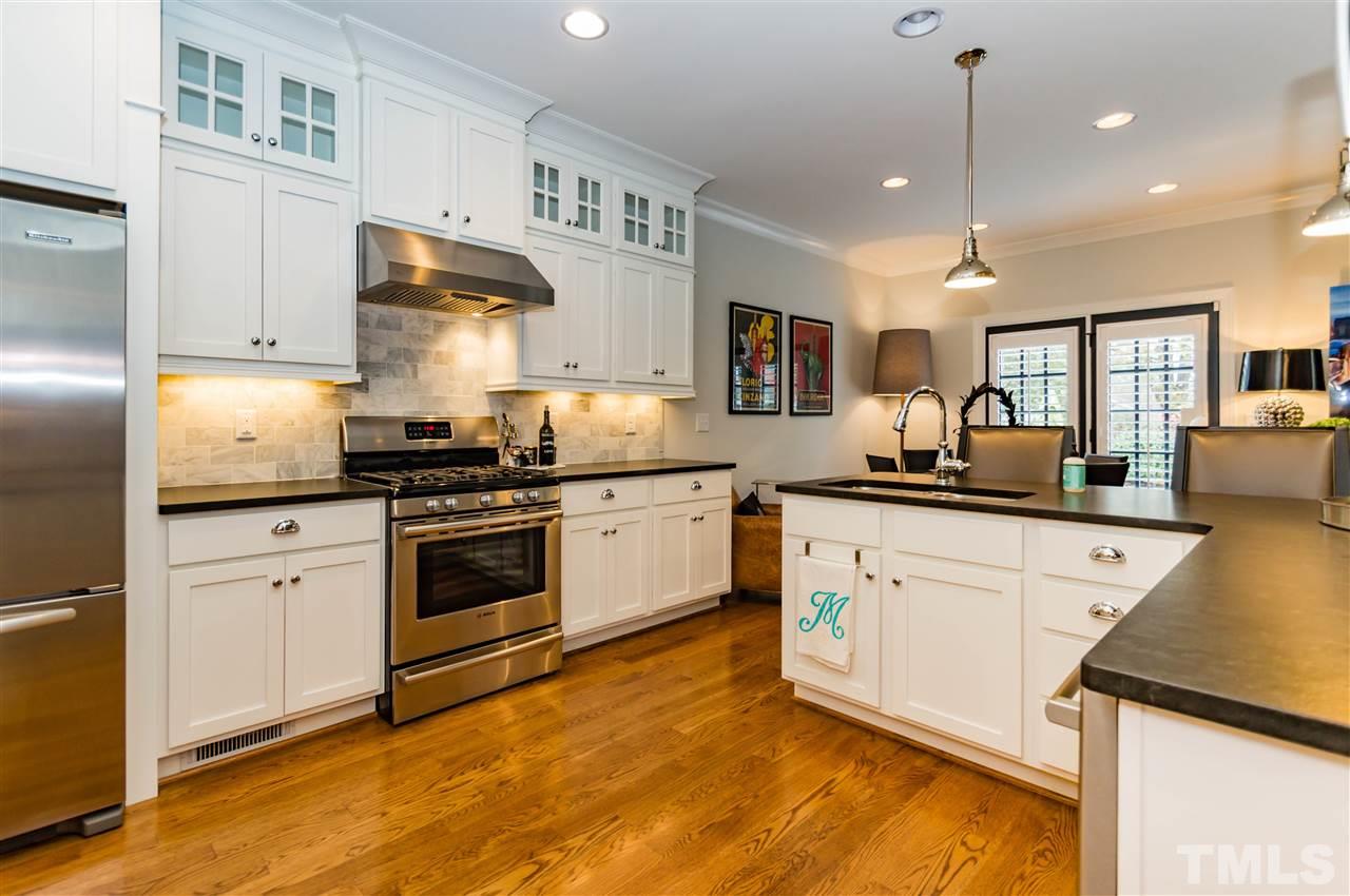 511 Mial Street Raleigh, NC 27608 - Photo 10 of 25 a kitchen with stainless steel appliances granite countertop a stove a sink and a refrigerator